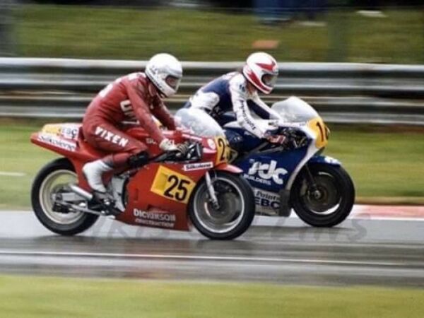 David Griffith Suzuki RGB500 MK9 Oulton Park diving up the inside of Keith Huewen